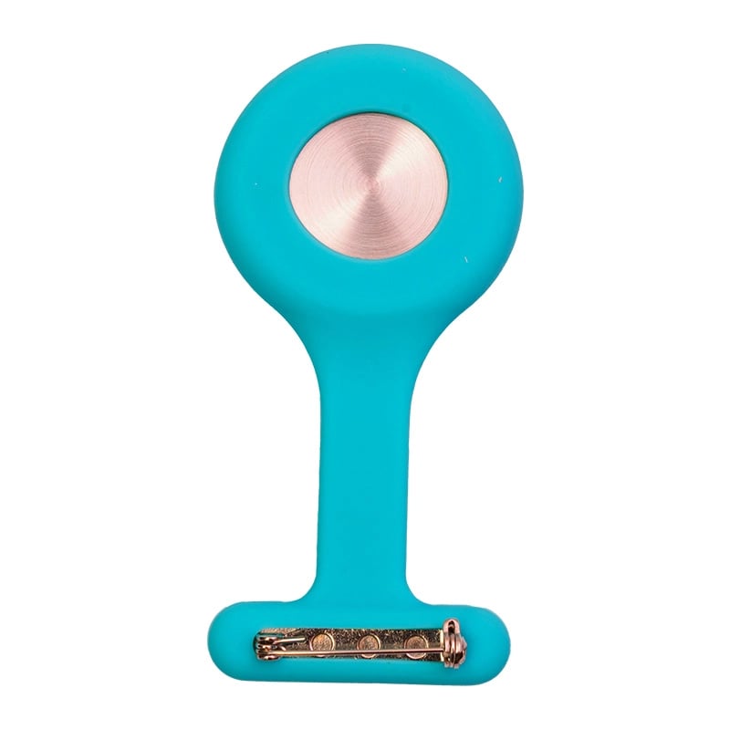 Reloj gmd color azul cielo, vista posterior, con carcasa de silicona en forma de “T”. En la parte superior presenta una tapa metálica circular de color plateado y en la parte inferior un broche para sujetarlo.. Haga clic para ampliar la imagen