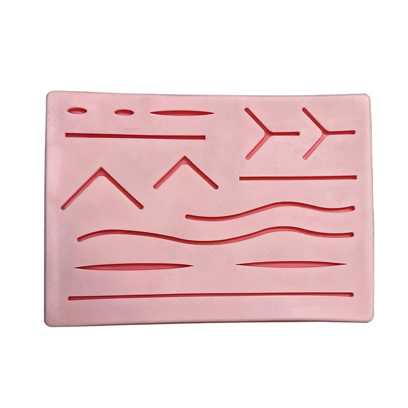 Pad de Suturas, de color rosado, fabricado en silicona de alta calidad. Su superficie es antideslizante.  Cuenta con diferentes tipos de suturas (14 en total).. Haga clic para ampliar la imagen