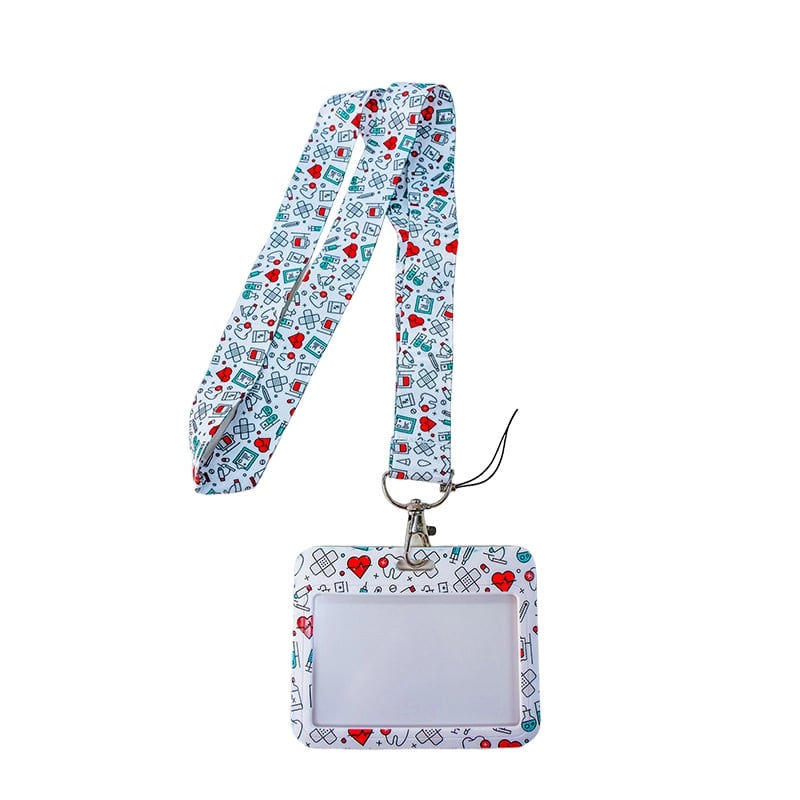 Porta carnet con lanyard diseño de muelitas, vista frontal, con borde rectangular de color blanco con ilustraciones de corazones, curas, muelitas, medicinas; en el centro área transparente para el carnet y en la parte superior gancho metálico con correa b. Haga clic para ampliar la imagen