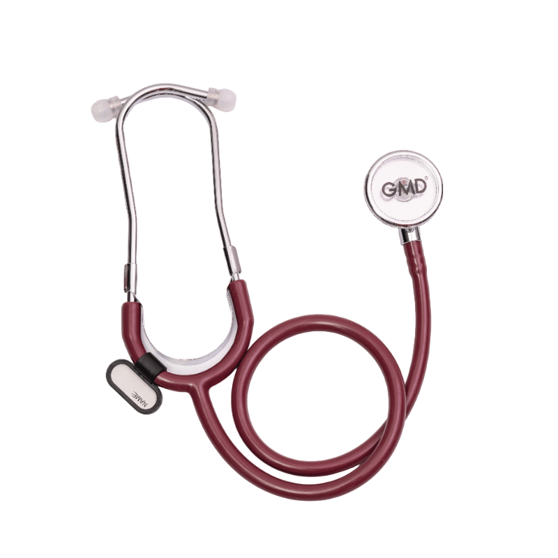 Fonendoscopio OIS 100S, tubo auricular metálico plateado en forma de Y con olivas blancas en los extremos. Sobre el tubo una pieza metálica que sujeta un reborde en forma de U de color blanco, la manguera color vino enrollada en la parte inferior, en el l. Haga clic para ampliar la imagen