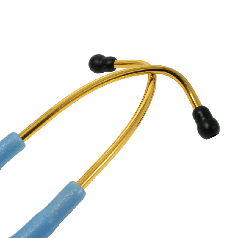 Fonendoscopio OIS 300, tubo auricular en forma de Y drorado con dos olivas de goma negra en cada extremo. Manguera flexible y de color azul cielo, ubicada en la parte inferior.. Haga clic para ampliar la imagen