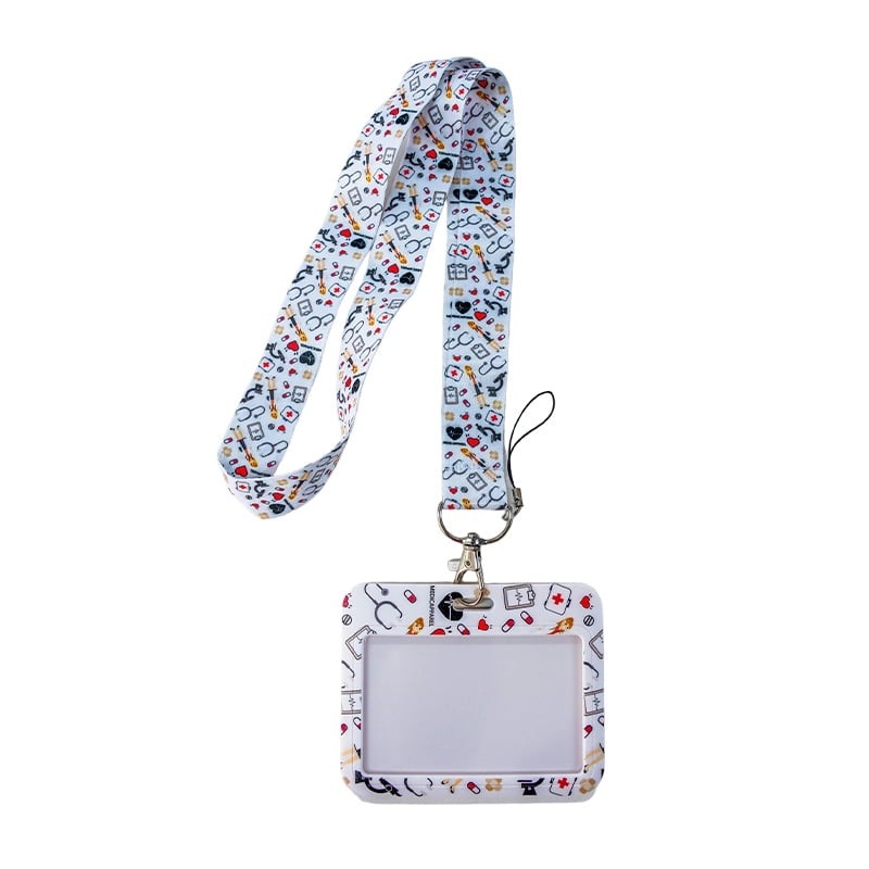 Porta carnet con lanyard diseño de fonendoscopios fondo blanco, vista frontal, con borde rectangular de color blanco con ilustraciones de corazones, muelitas, doctoras, fonendoscopios, medicinas; en el centro área transparente para el carnet y en la parte. Haga clic para ampliar la imagen
