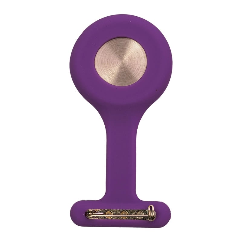Reloj gmd color purpúra, vista posterior, con carcasa de silicona en forma de “T”. En la parte superior presenta una tapa metálica circular de color plateado y en la parte inferior un broche para sujetarlo.. Haga clic para ampliar la imagen